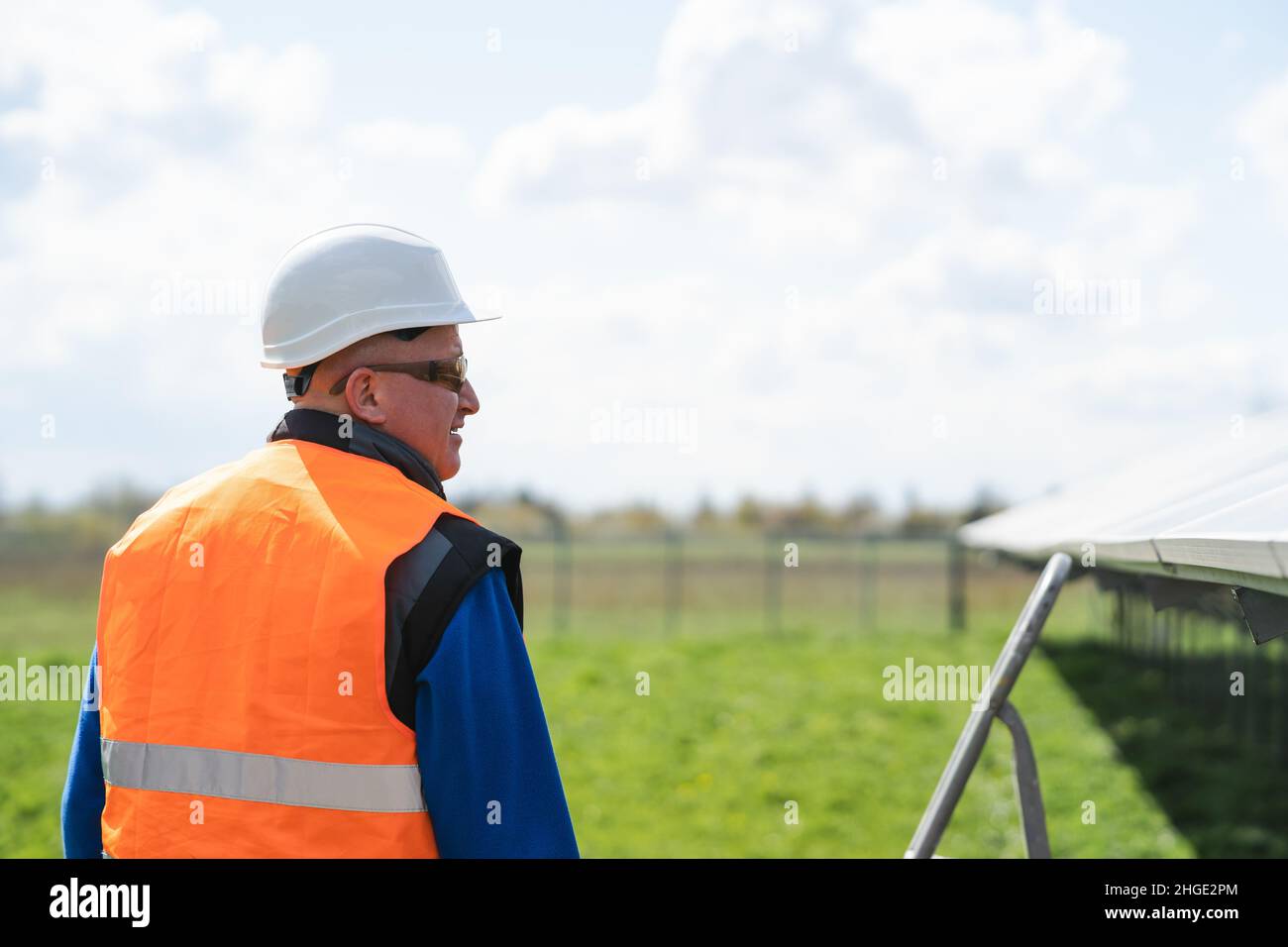 Back view of worker at solar panels farm Stock Photo Alamy