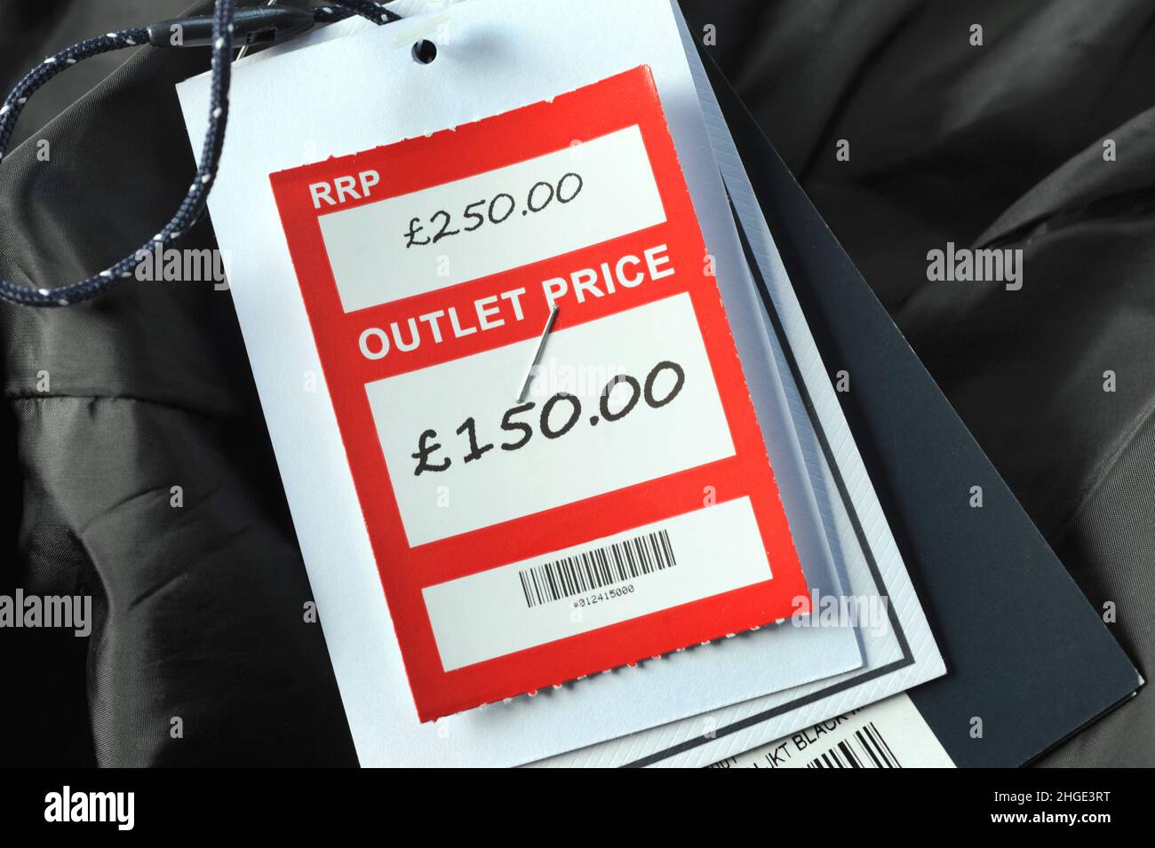 RETAIL CLOTHING OUTLET PRICE TAGS RE SALES DISCOUNT COST OF LIVING HIGH STREET SHOPS ETC UK Stock Photo