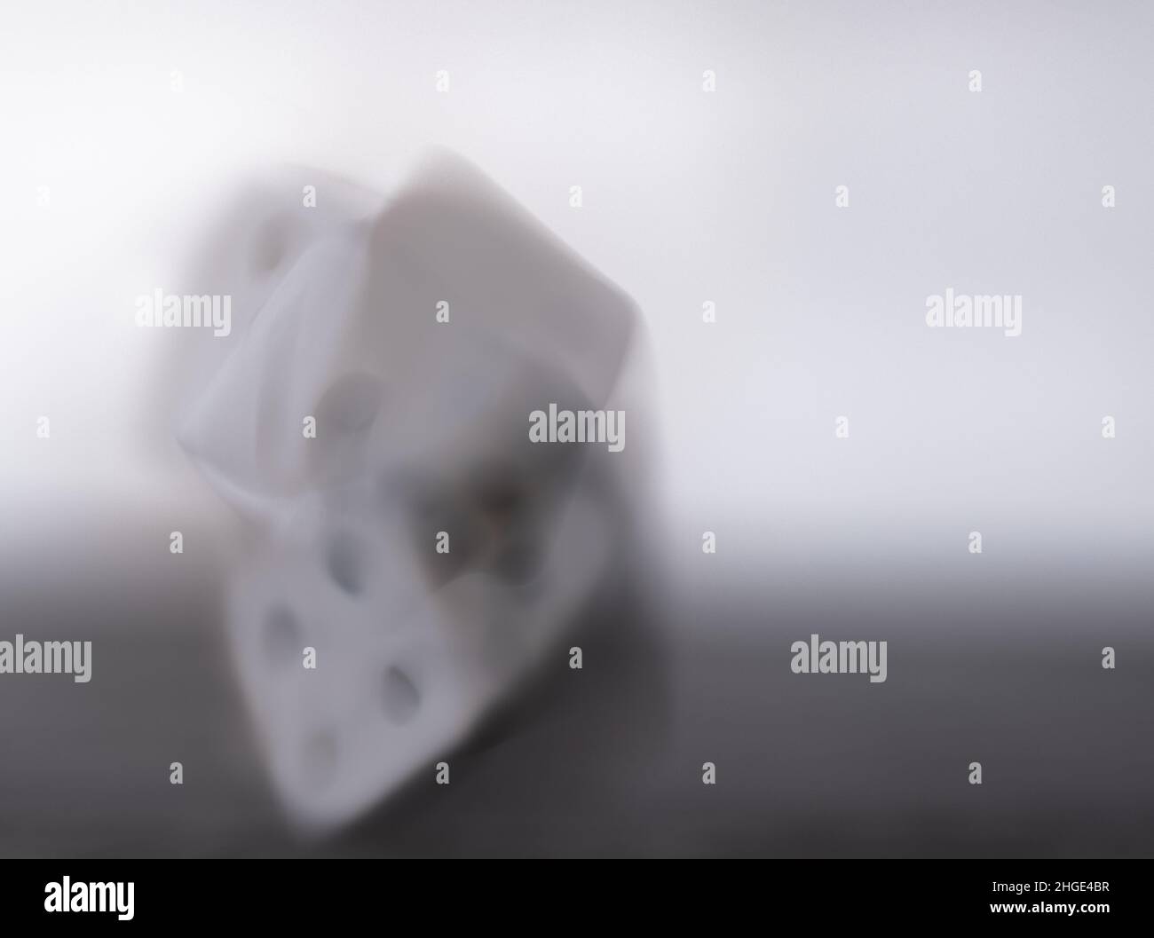 Blurry rolling dice on black and white background Stock Photo