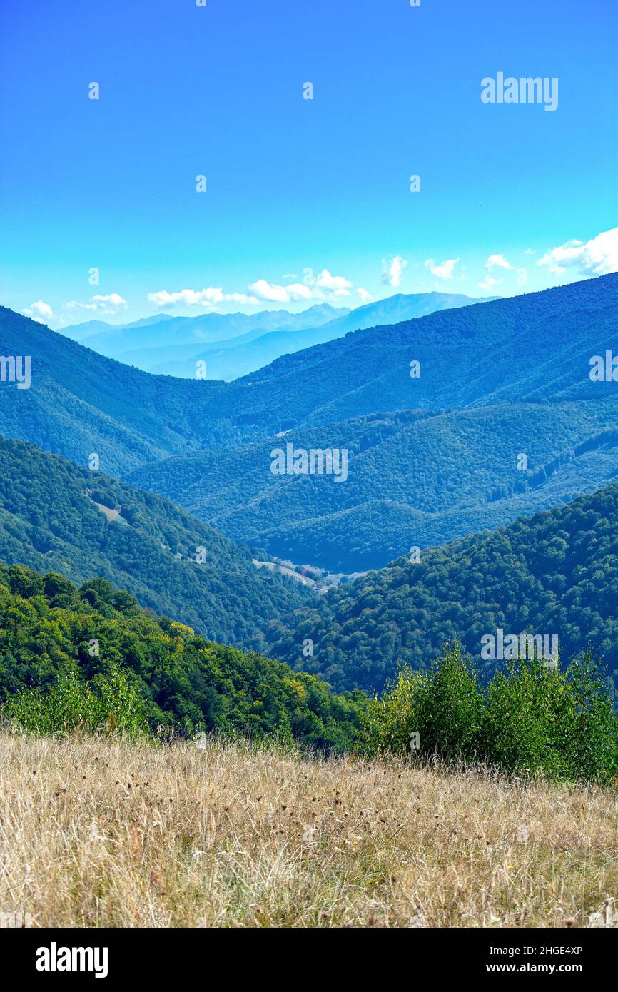 Landscaoe in Carpathians, Transylvania, Romania, in Sibiu county, Sadu valley in Cindrel mountains and Fagaras range in background Stock Photo