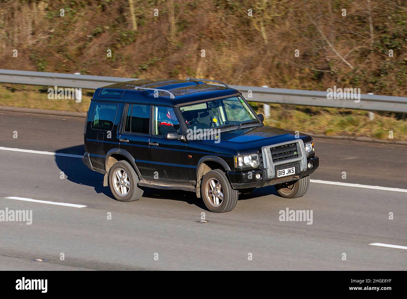 2003 black Land Rover Discovery 2495cc Diesel 5 speed H Vehicular traffic, moving vehicles, cars, vehicle driving on UK roads, motors, motoring on the M61 motorway highway UK road network. Stock Photo
