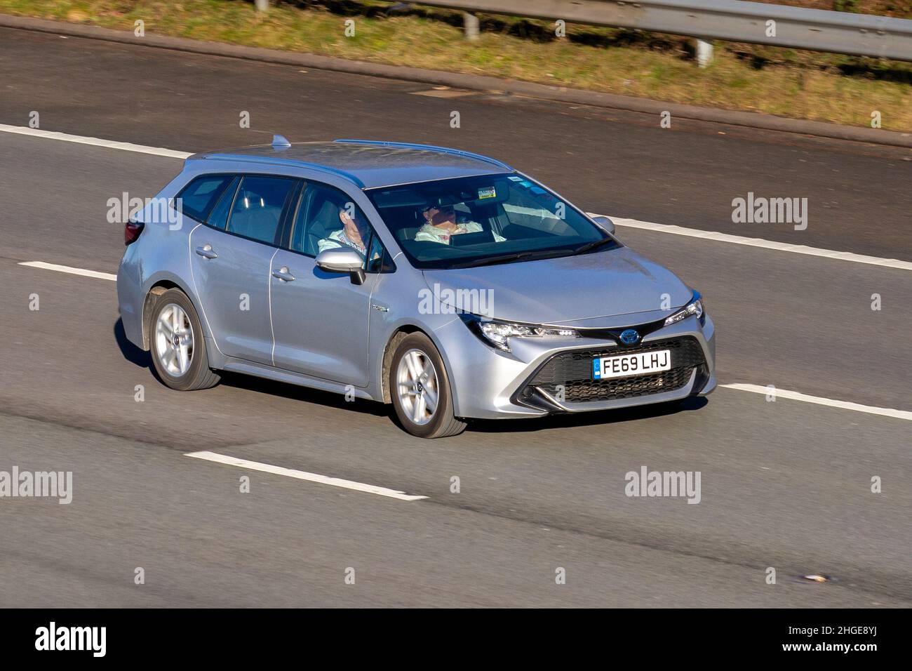 2019 silver Toyota Corolla VVT-I Icon Tech 1987cc hybrid electric, Vehicular traffic, moving vehicles, cars, vehicle driving on UK roads, motors, motoring on the M61 motorway highway UK road network. Stock Photo