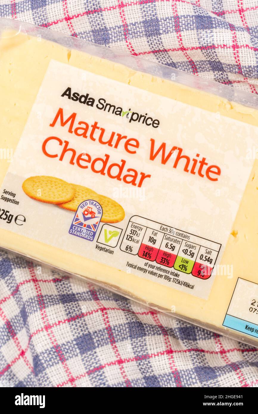 Plastic wrapper of ASDA budget own-label Mature Cheddar Cheese with dietary food label traffic light system showing cheese fat content, salt, etc. Stock Photo