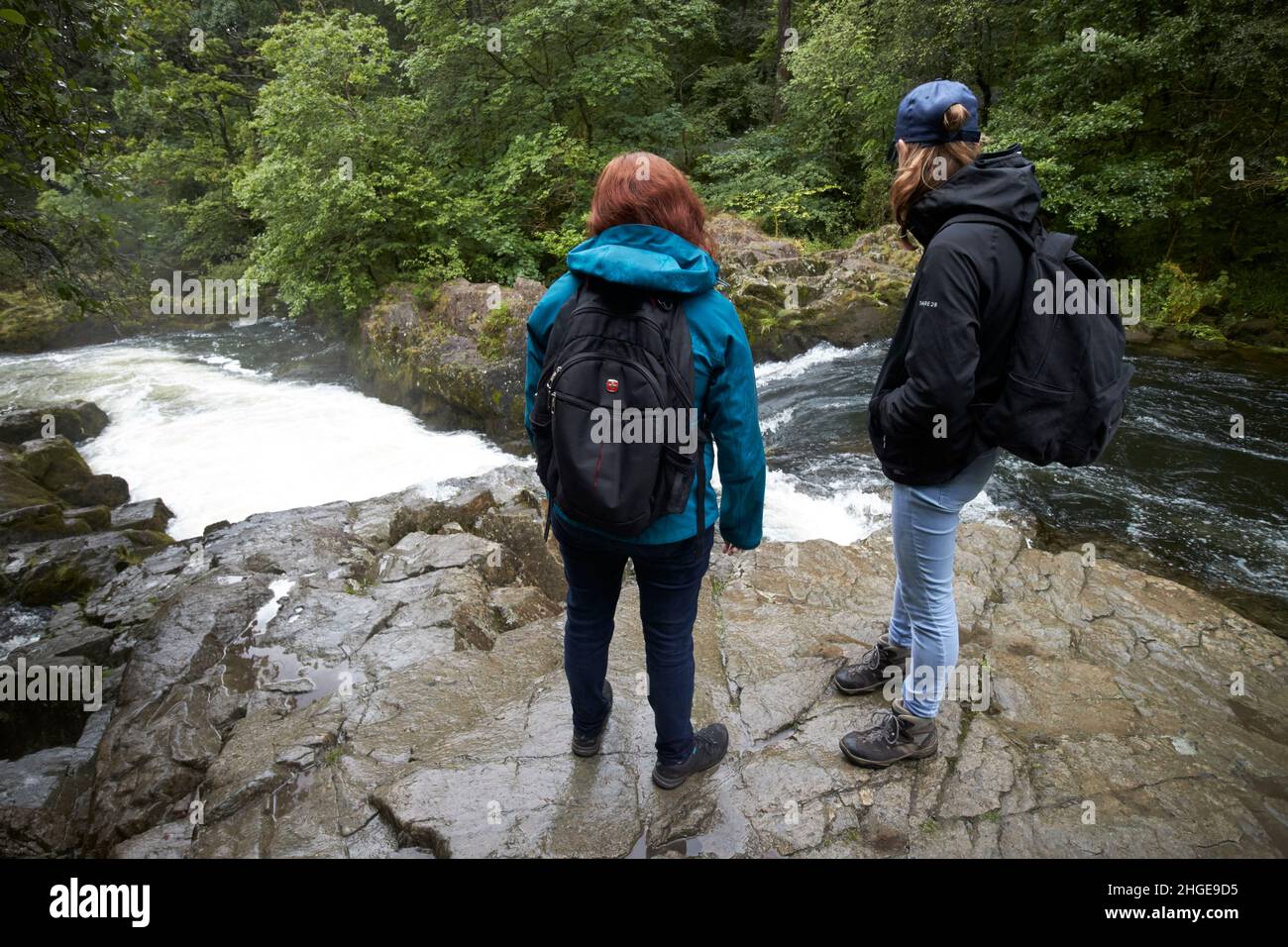 tourists stand a the top of skelwith force waterfall on the river brathay near ambleside  lake district, cumbria, england, uk Stock Photo