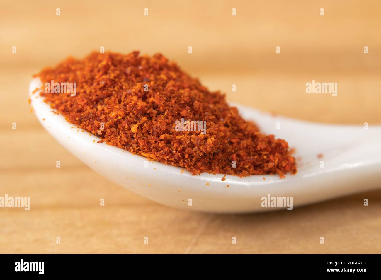 Macro of cayenne pepper in a small white spoon Stock Photo