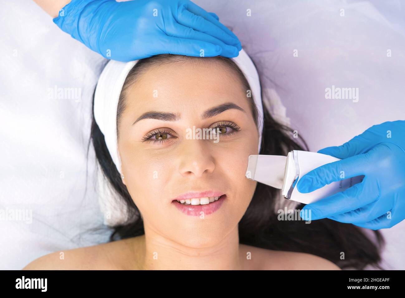 Close up photo of a woman lying on couch in cosmetological clinic with