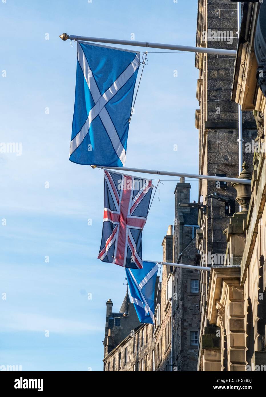 Union Jack and Scottish Saltire flags hang outside the Edinburgh City Chambers on the High Street, Edinburgh. Stock Photo