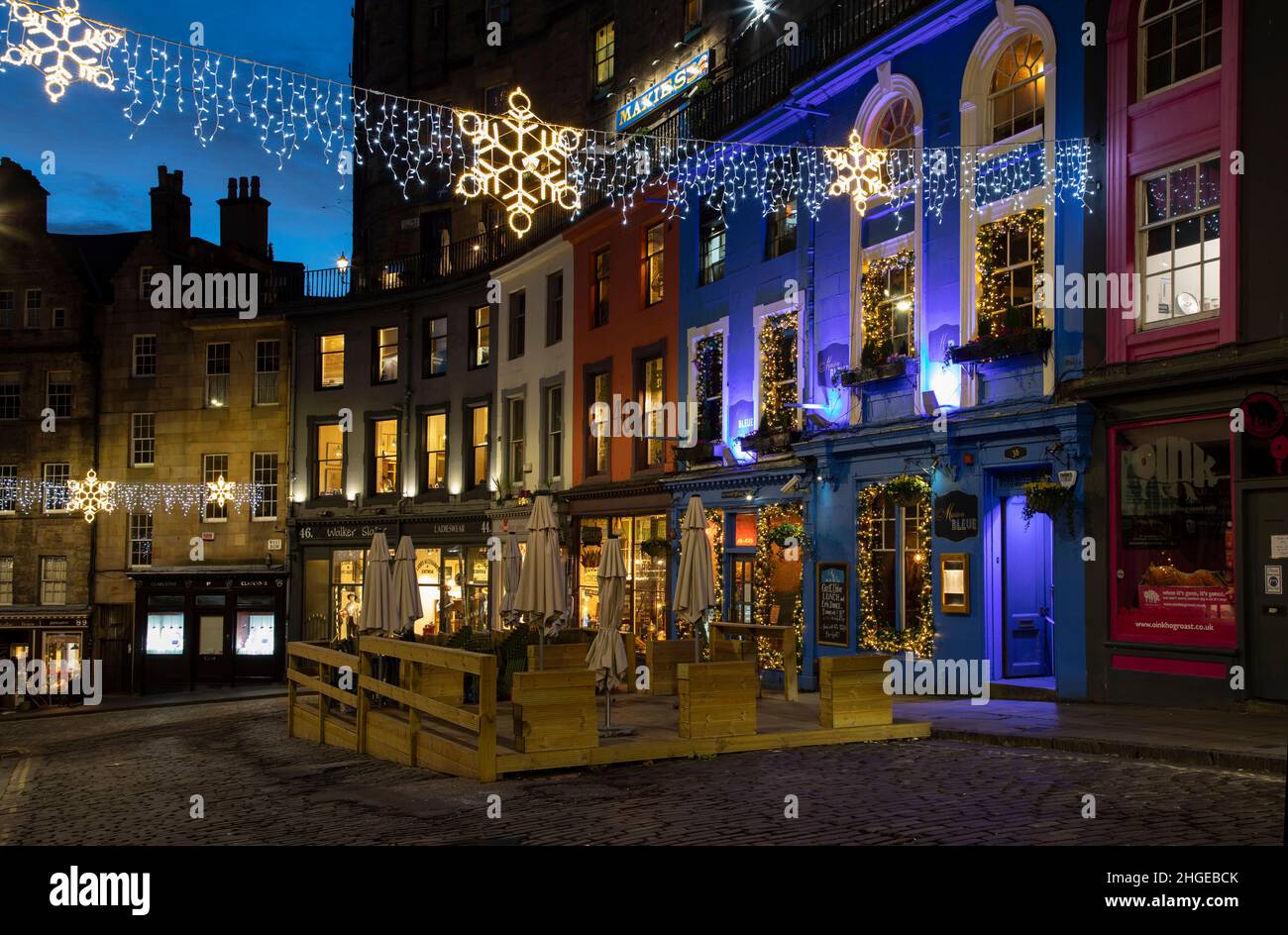 Edinburgh, UK - January 4th, 2022: Victoria Street is at the pretty part of Old Town Edinburgh with a long stretch of colourful storefronts and restau Stock Photo