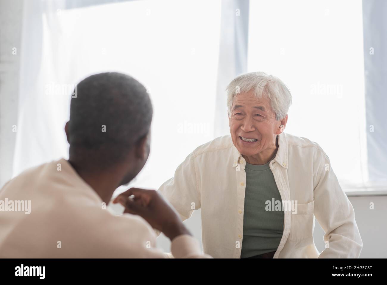 Smiling friends home asian man hi-res stock photography and images - Alamy
