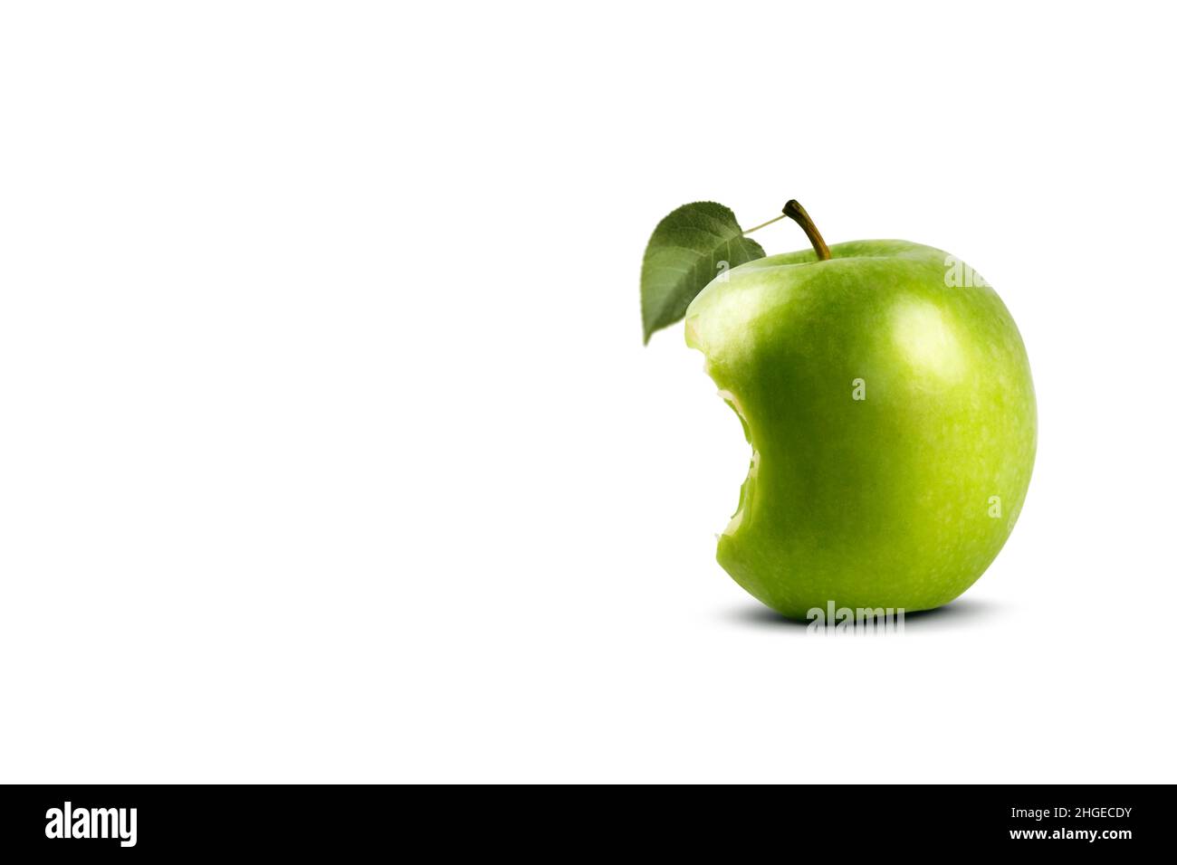 Bitten Granny Smith apple with a leaf on a white background. Stock Photo