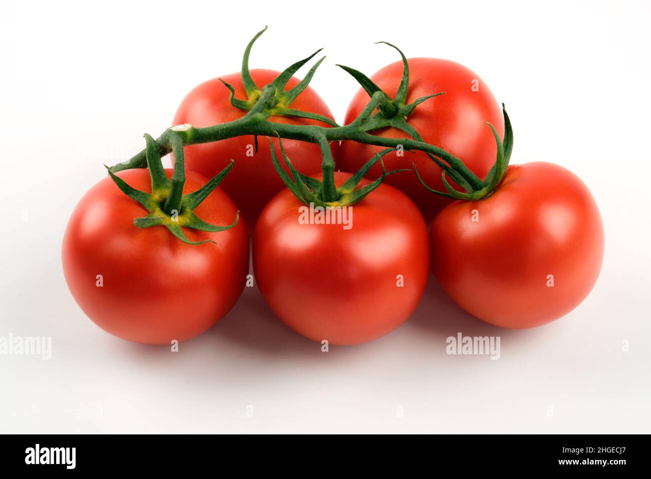 Close up shot of cluster tomatoes on a white background Stock Photo