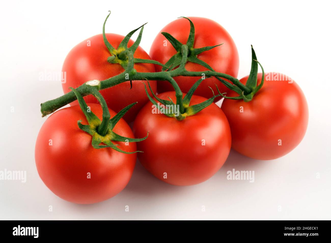 Close up shot of cluster tomatoes on a white background Stock Photo