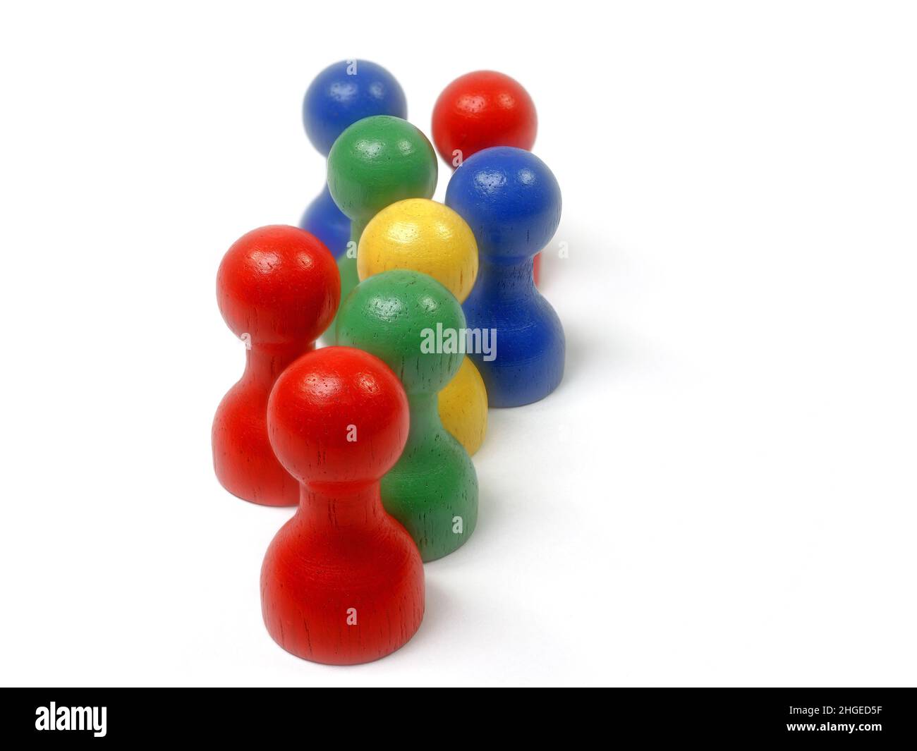 Eight colorful wooden skittles against a white background Stock Photo