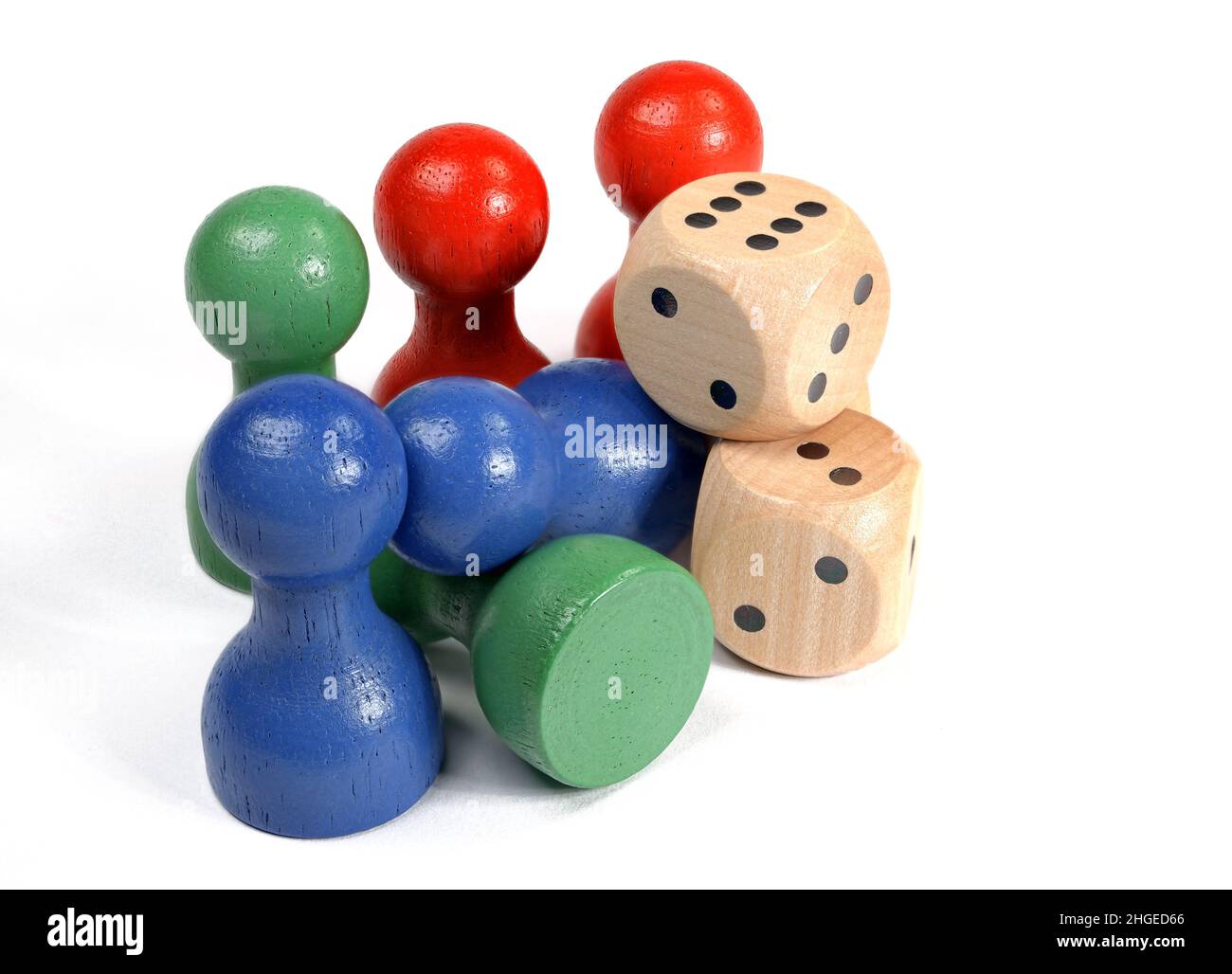 Colorful wooden skittles and dice against white background Stock Photo