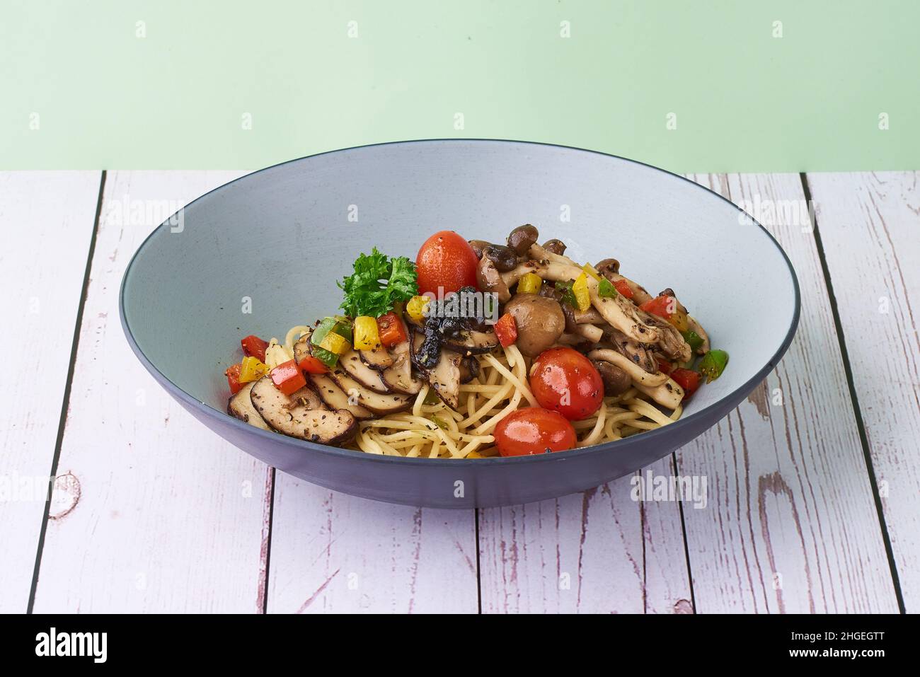 Pasta truffle Aglio Oglio with mushroom and tomatoes in a bowl on