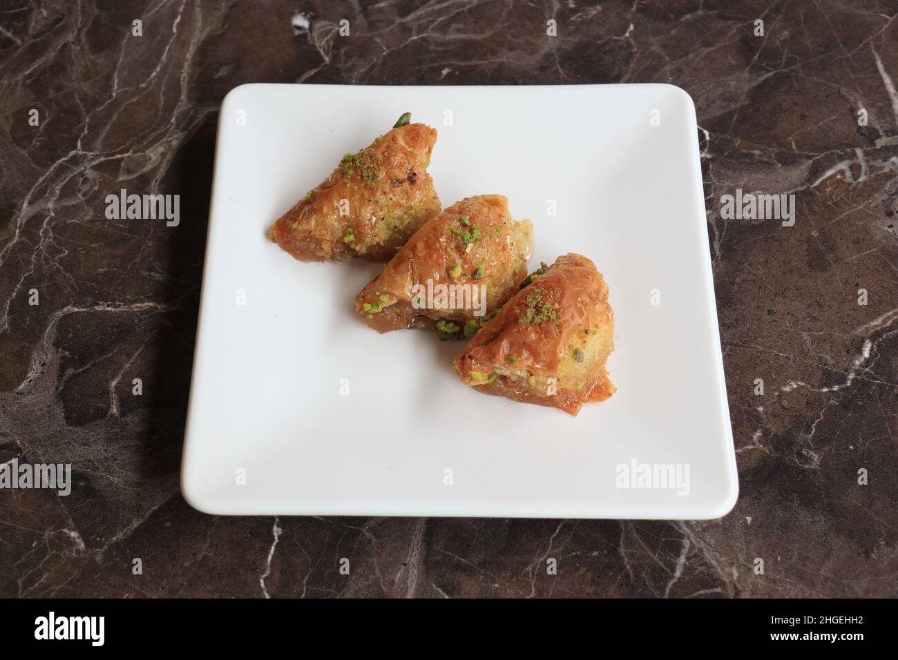 Baklava is a layered pastry dessert made of filo pastry, filled with
