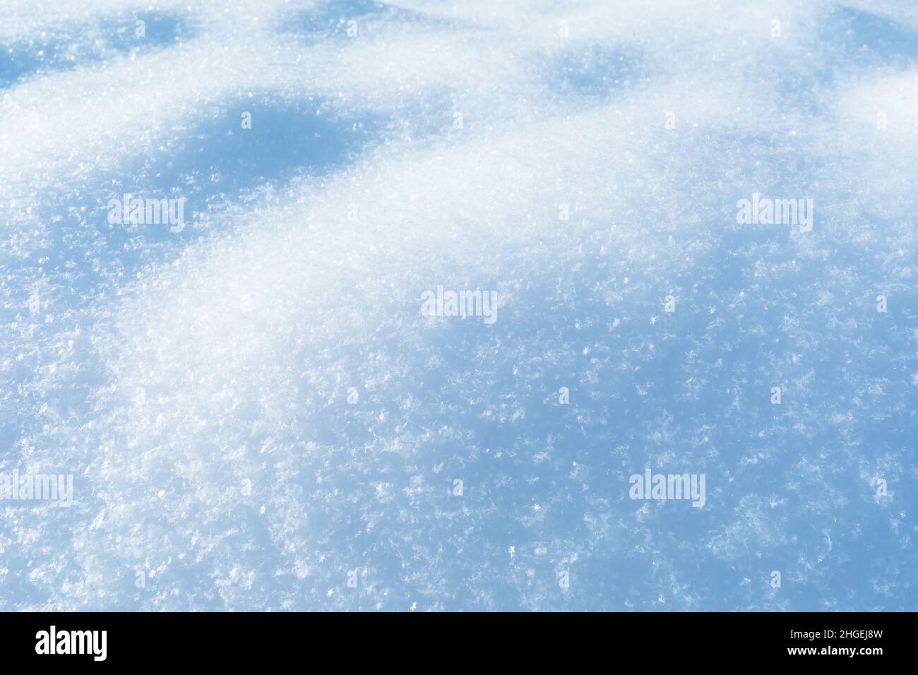 Snow texture illuminated by sunlight, snow background Stock Photo