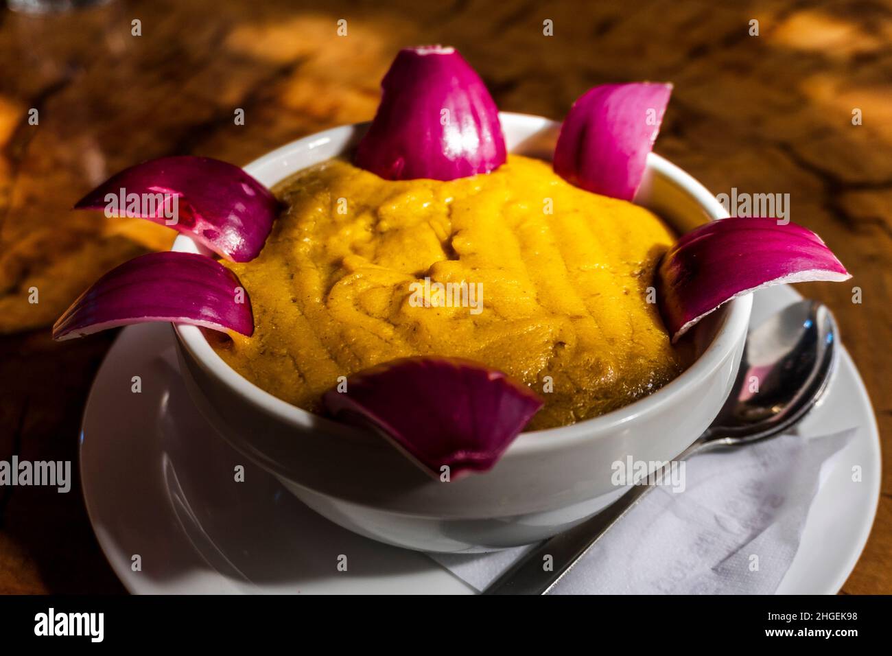 Delicious traditional food from Gran Canaria called Gofio Escaldado is to be eaten with raw red onion. Stock Photo