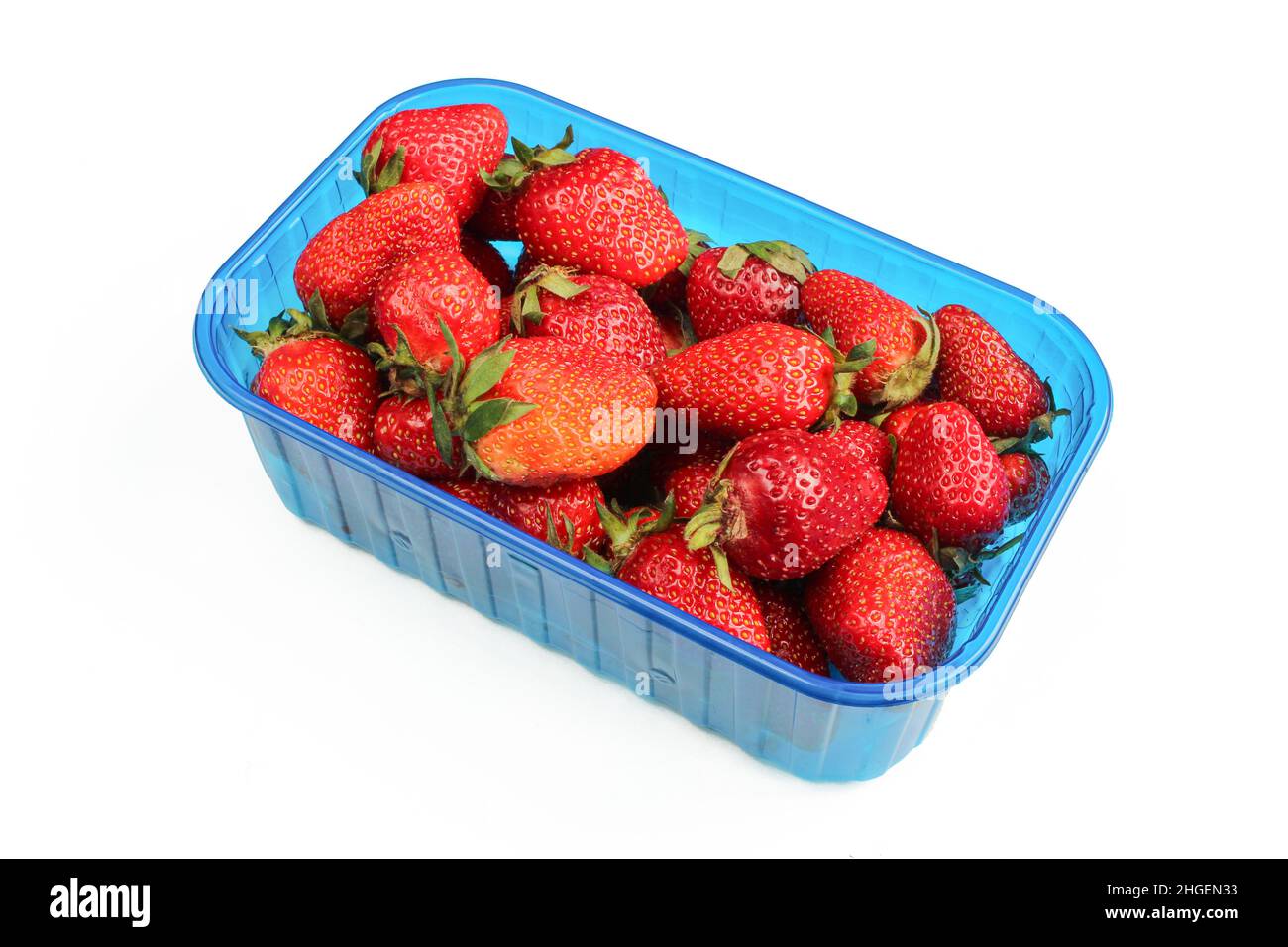 Fresh strawberries in plastic container isolated on white background Stock Photo