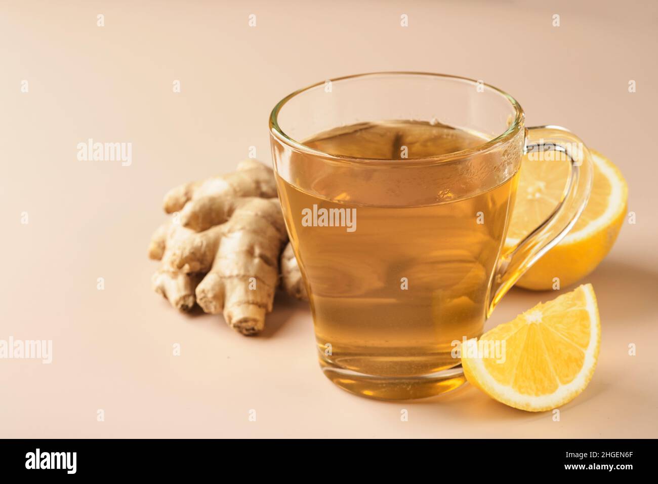 Ginger tea. Cup of ginger tea with lemon, honey and mint on beige