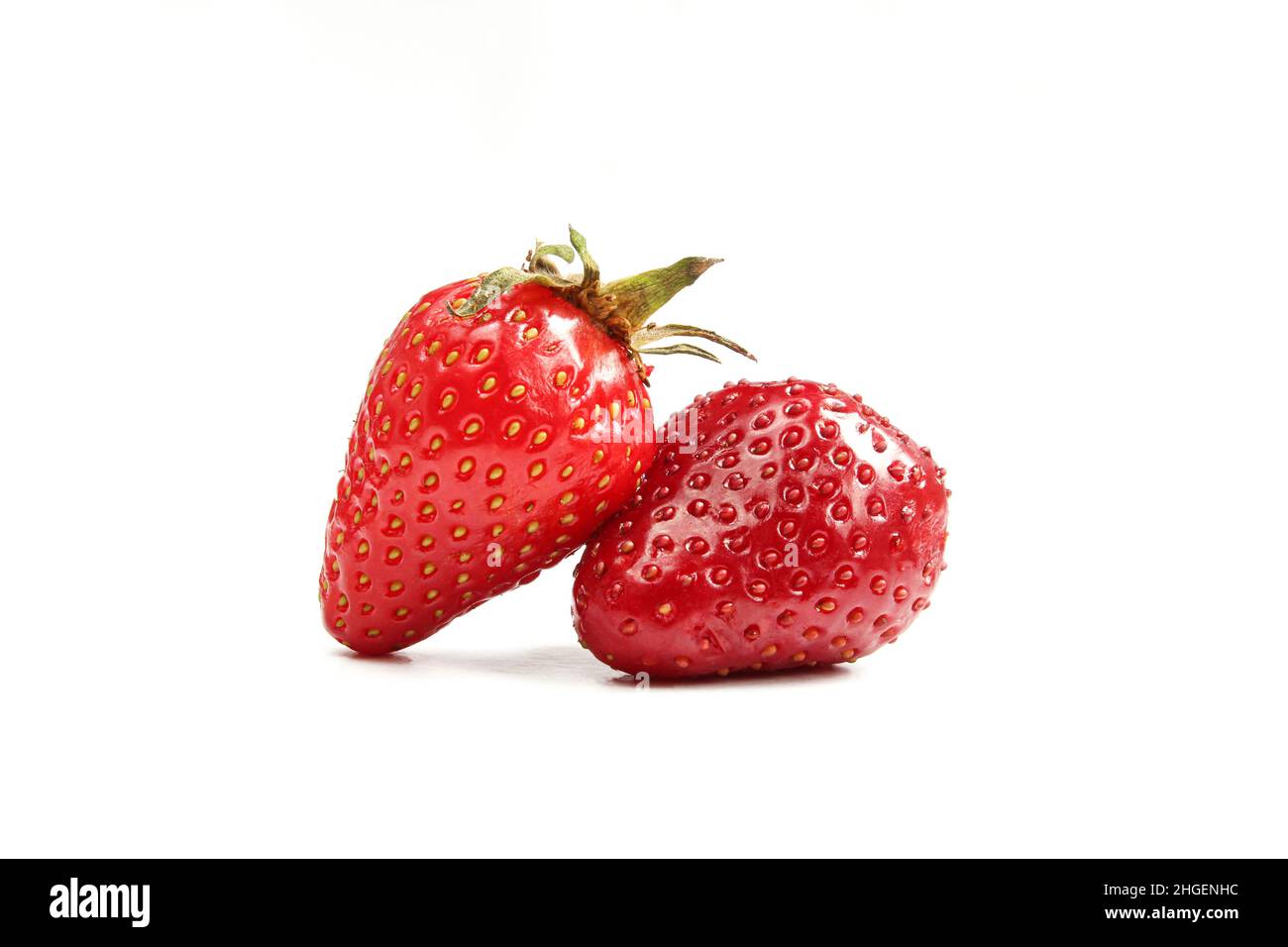 Two shiny strawberries isolated on white background Stock Photo - Alamy