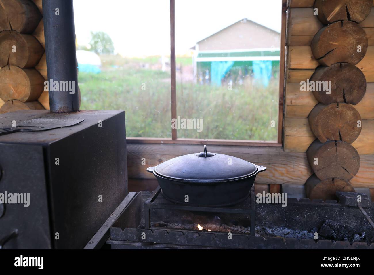 https://c8.alamy.com/comp/2HGENJX/cooking-soup-in-cauldron-on-fire-in-gazebo-2HGENJX.jpg