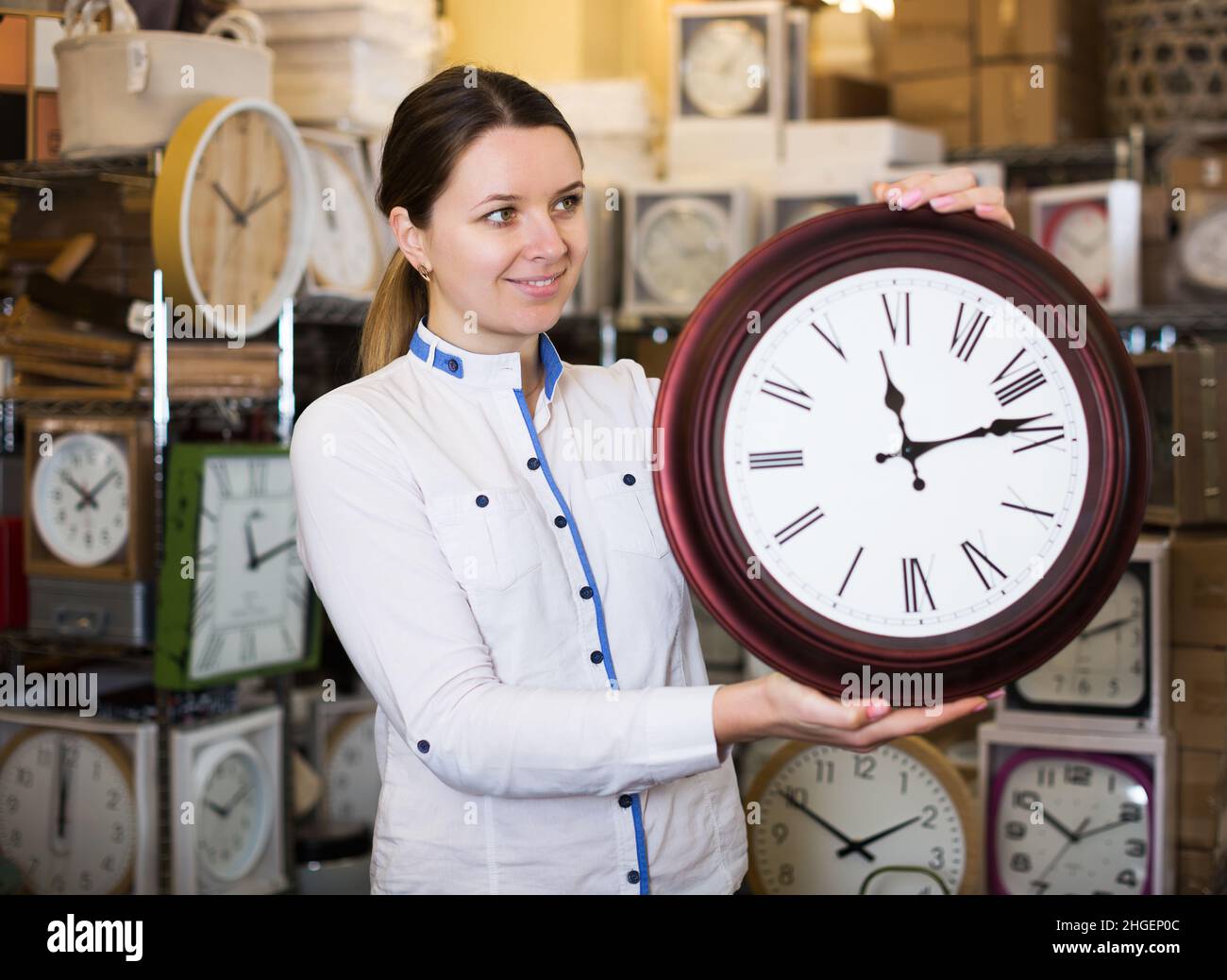 woman is holding clock Stock Photo - Alamy
