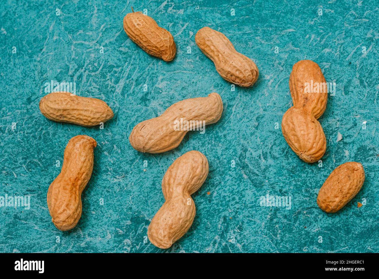 Nuts peanuts in a peel on a beautiful blue background. Healthy foods ...