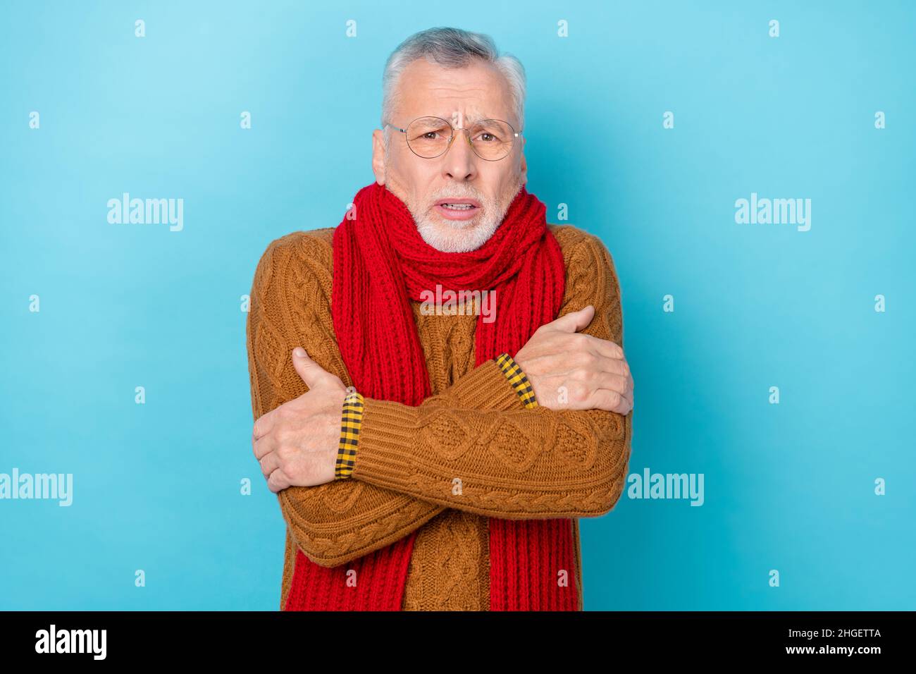 Photo of upset man touch hands infection shoulders bad feel frosty isolated blue color background Stock Photo