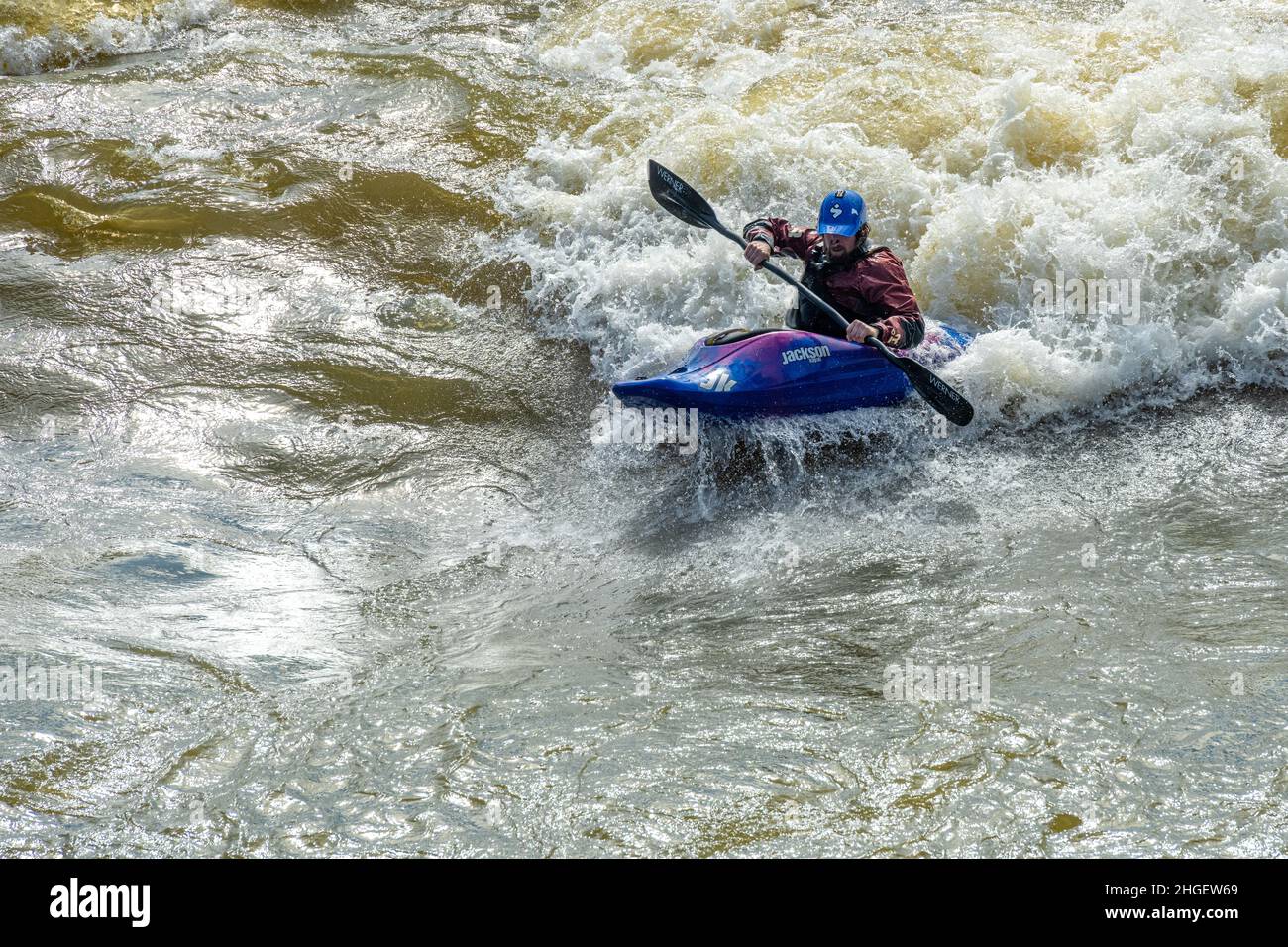 Kayaker navigating whitewater rapids on the Chattahoochee River at RushSouth Whitewater Park along Uptown Columbus, Georgia. (USA) Stock Photo
