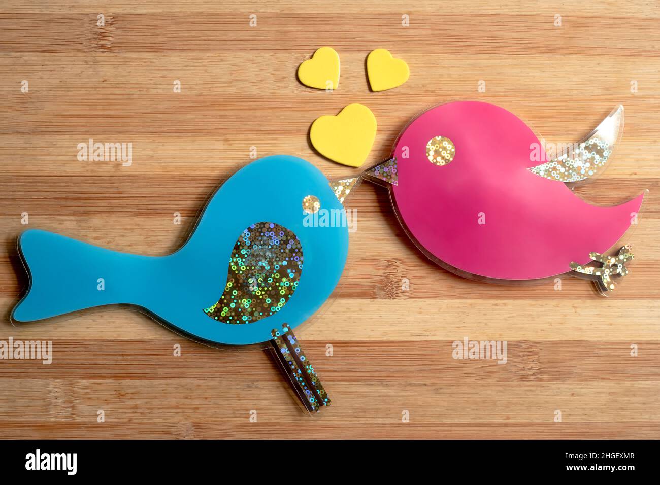 Happy couple of birds in love on a wooden table, Valentine concept Stock Photo