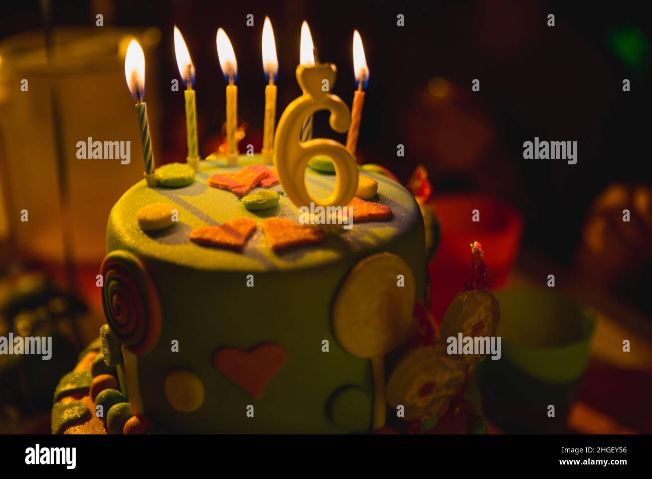 Birthday multicolored cake with burning candles and age 6 candle ...