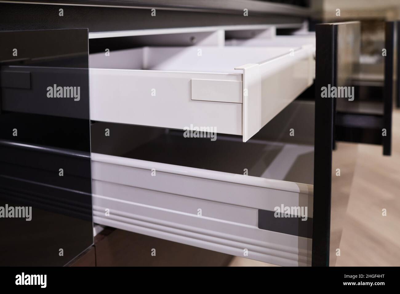 Modern kitchen with open cutlery drawer inserts. Stock Photo