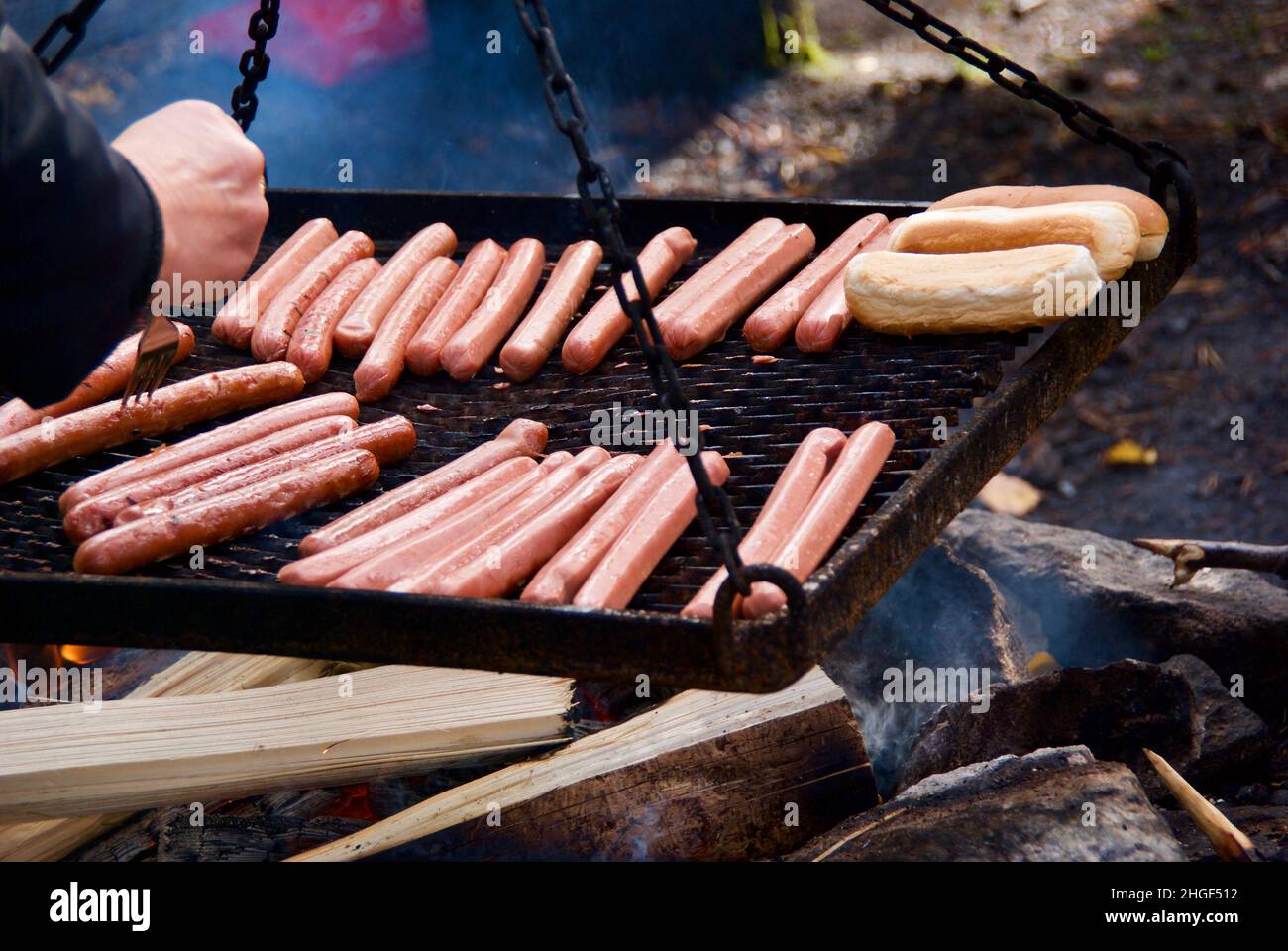 Barbecue sausage and sausage bread on the grill outdoors at a barbecue