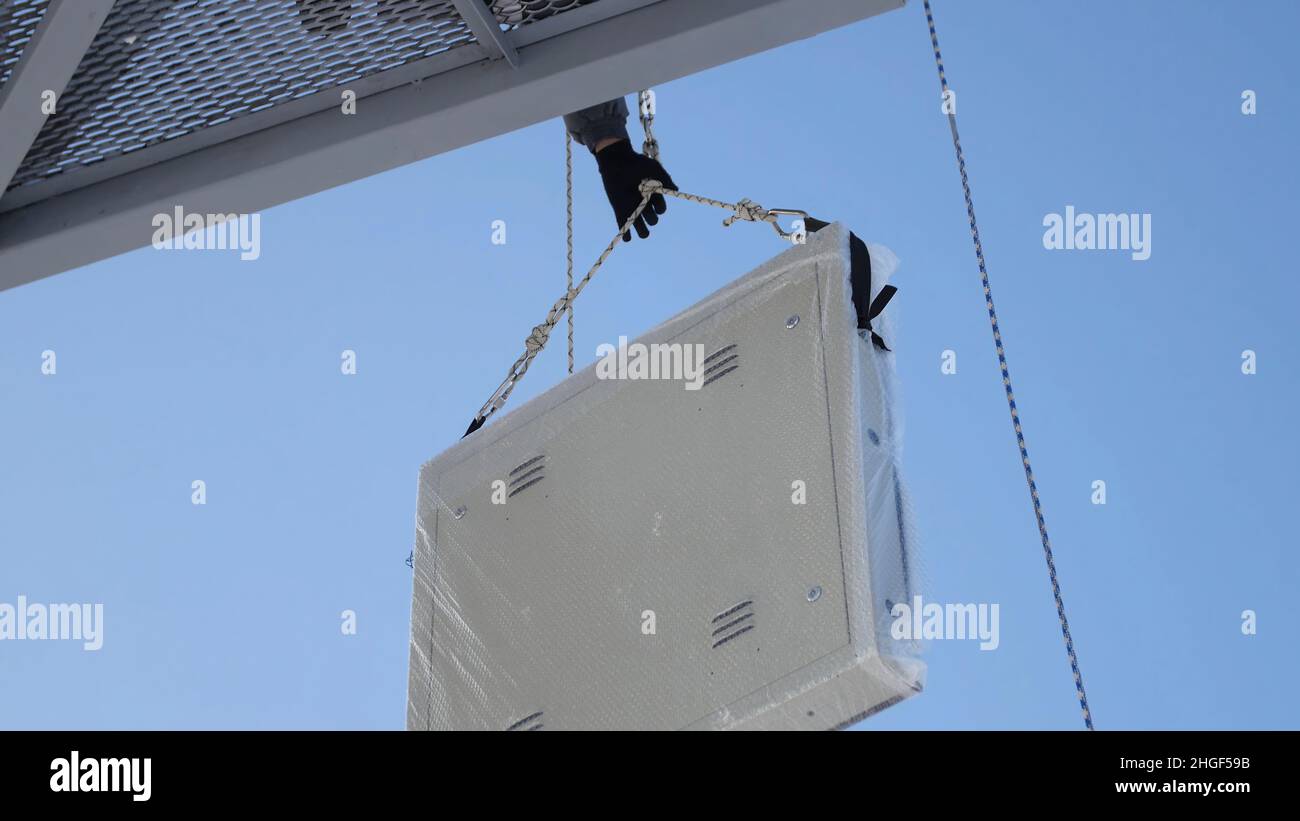 Men assemble Billboard on tap. Builder on a Lift Platform at a ...