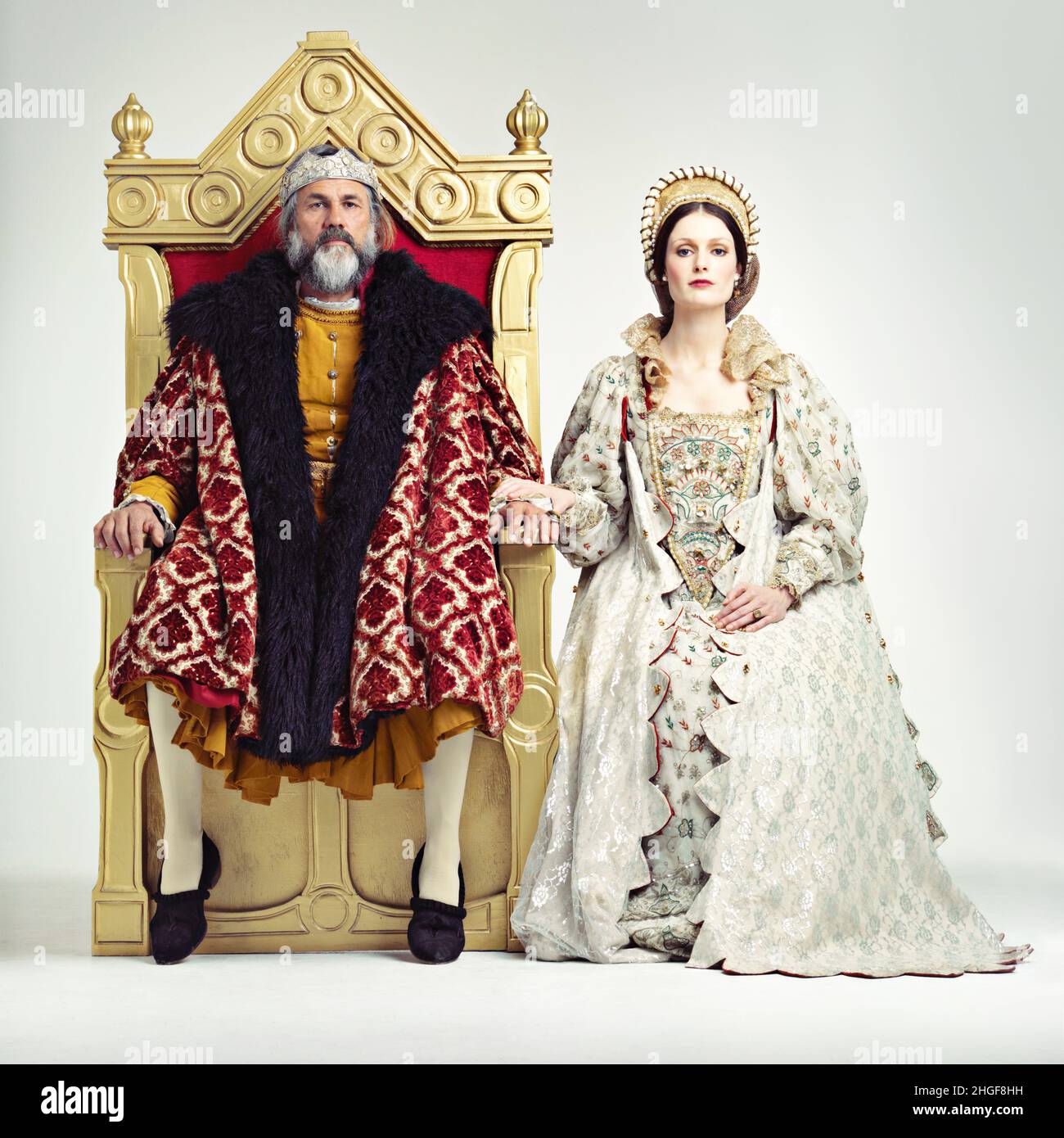 They rule sternly but fairly. Studio shot of a king and queen sitting