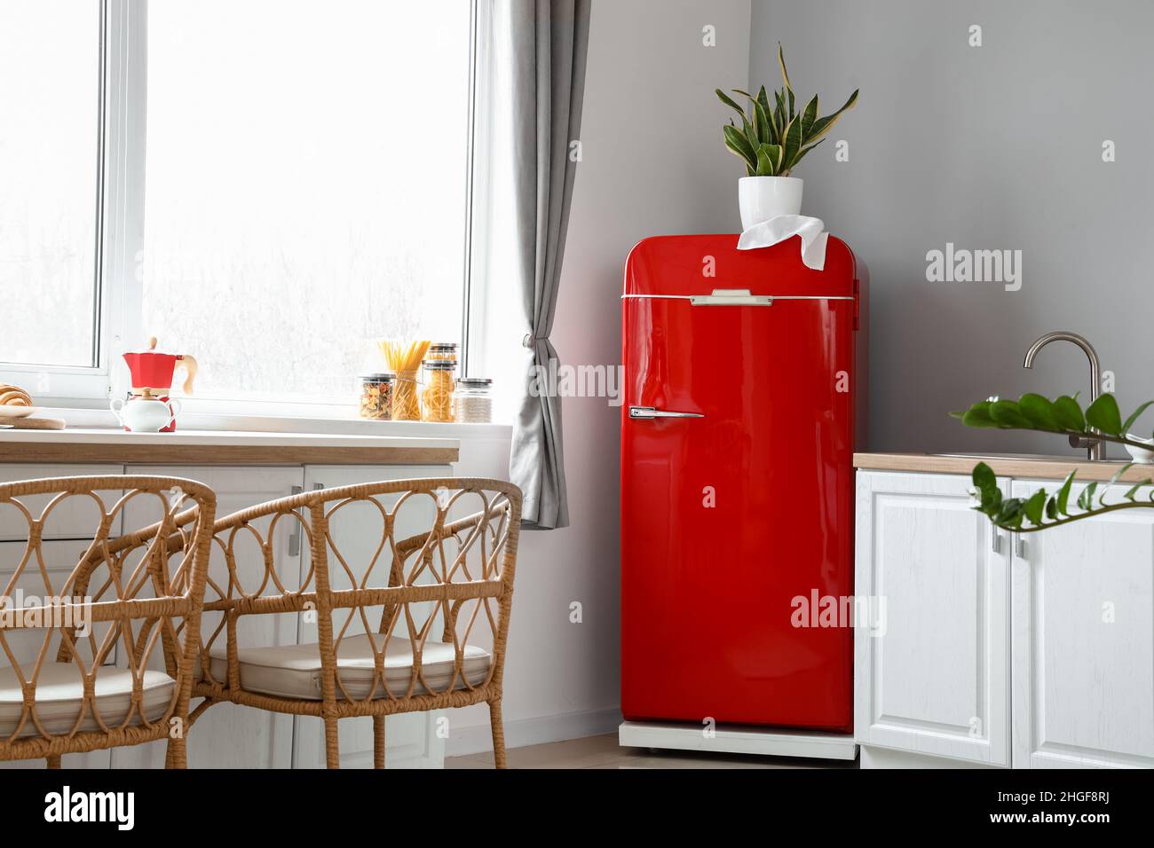 Interior of light modern kitchen with red fridge, white counters and ...