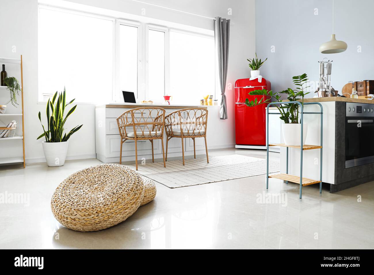 Interior of light modern kitchen with red fridge, white counters and ...