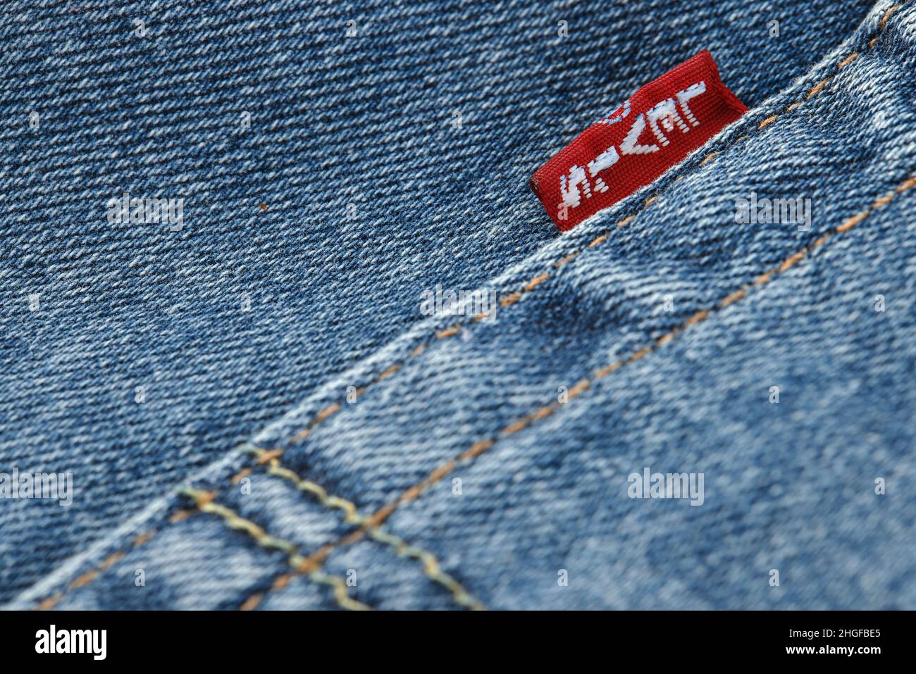 Close up of the details of new LEVI'S 501 Jeans. Seams and denim texture close-up. Classic jeans model. LEVI'S is a brand name of Levi Strauss and Co, Stock Photo