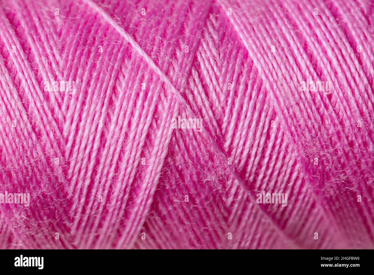 Pink sewing threads as background Stock Photo - Alamy