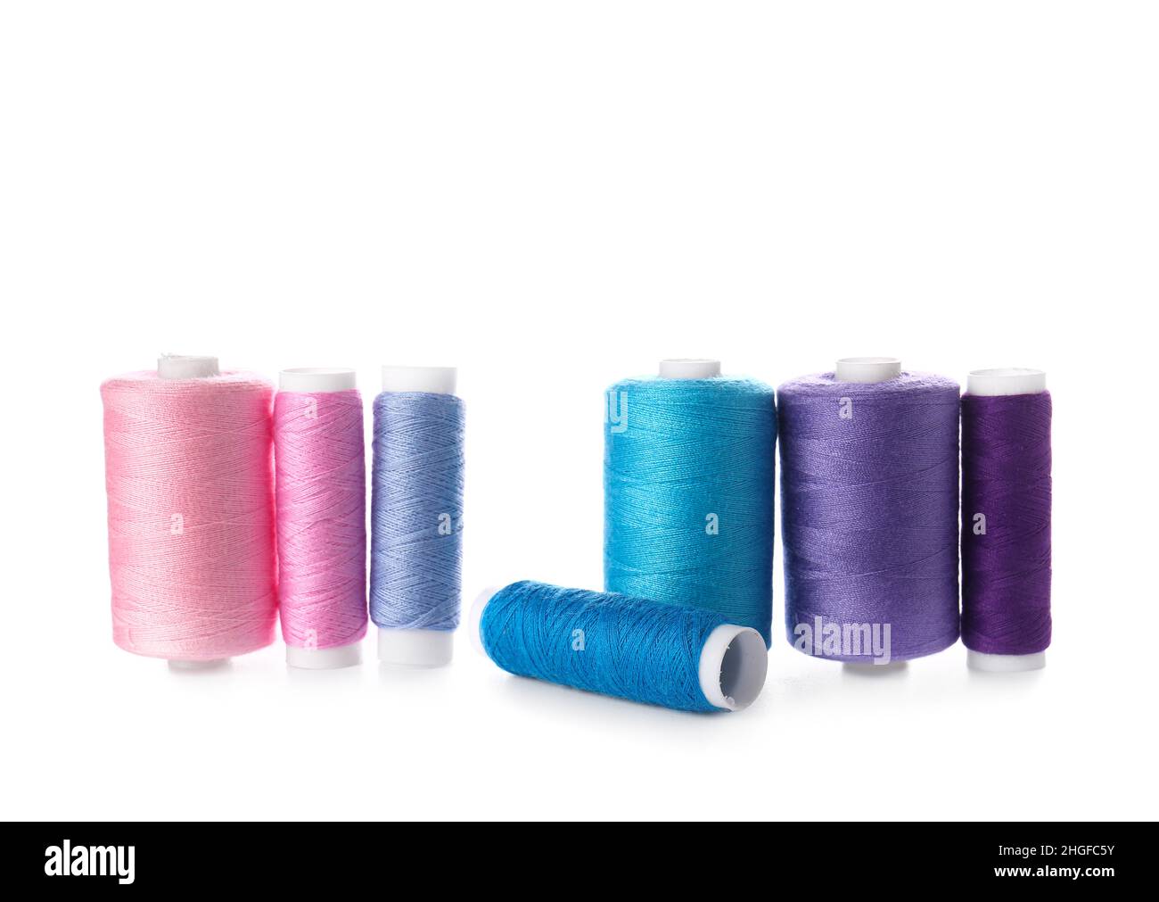 Different sewing thread spools on white background Stock Photo - Alamy