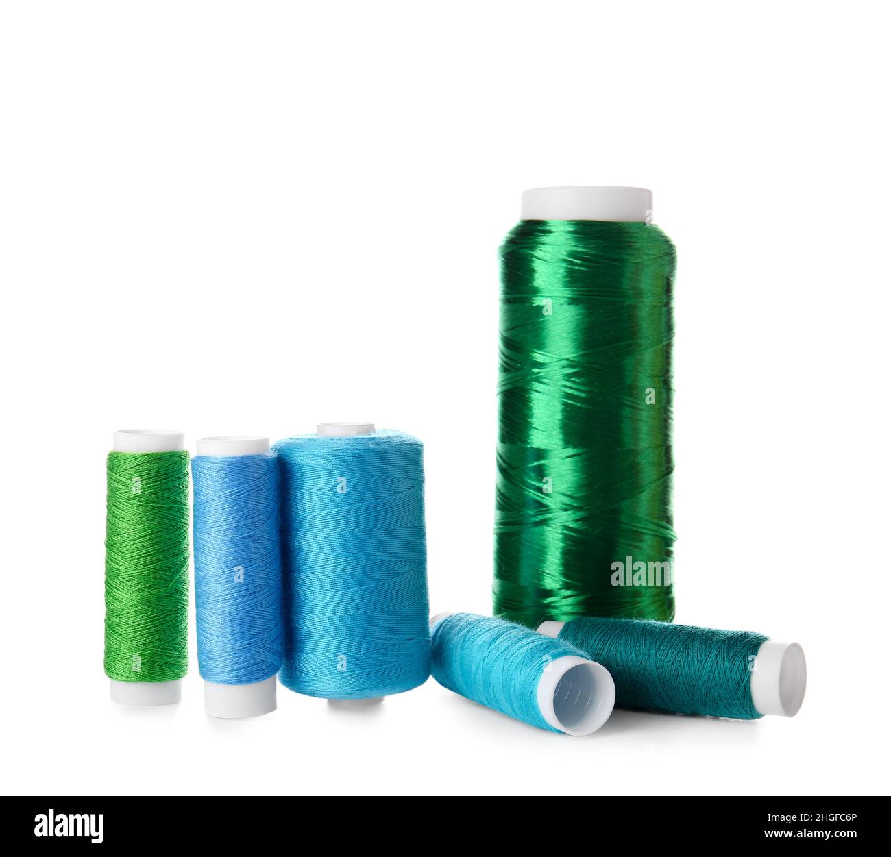 Different sewing thread spools on white background Stock Photo - Alamy