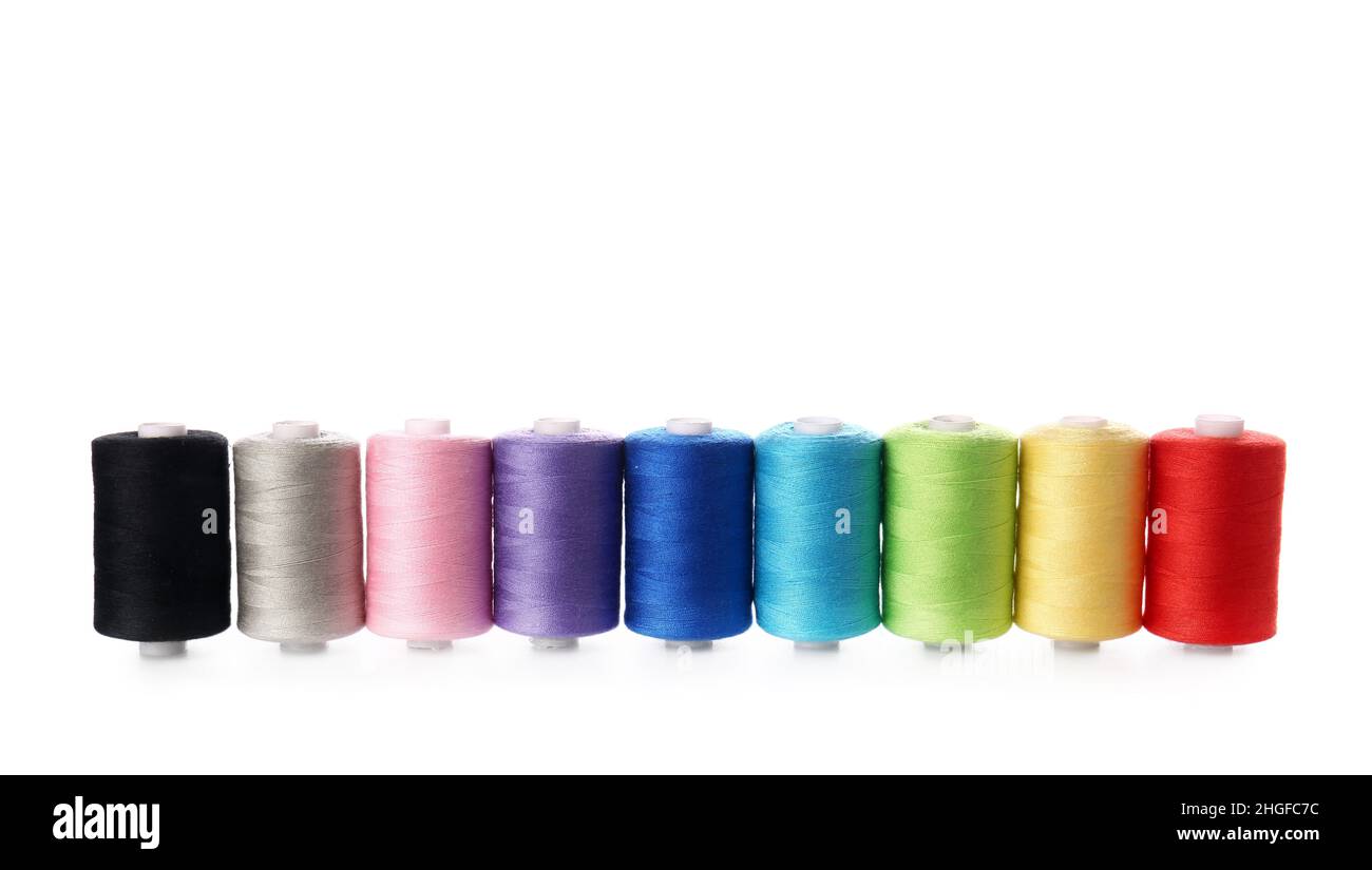 Different sewing thread spools on white background Stock Photo - Alamy