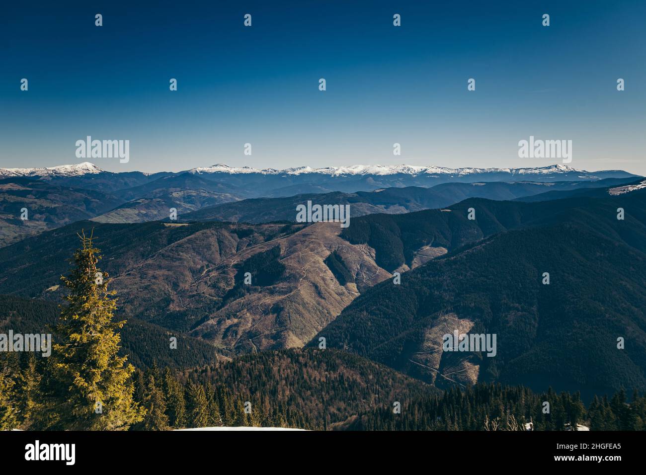 Landscape of snow-capped peaks, late winter early spring Stock Photo