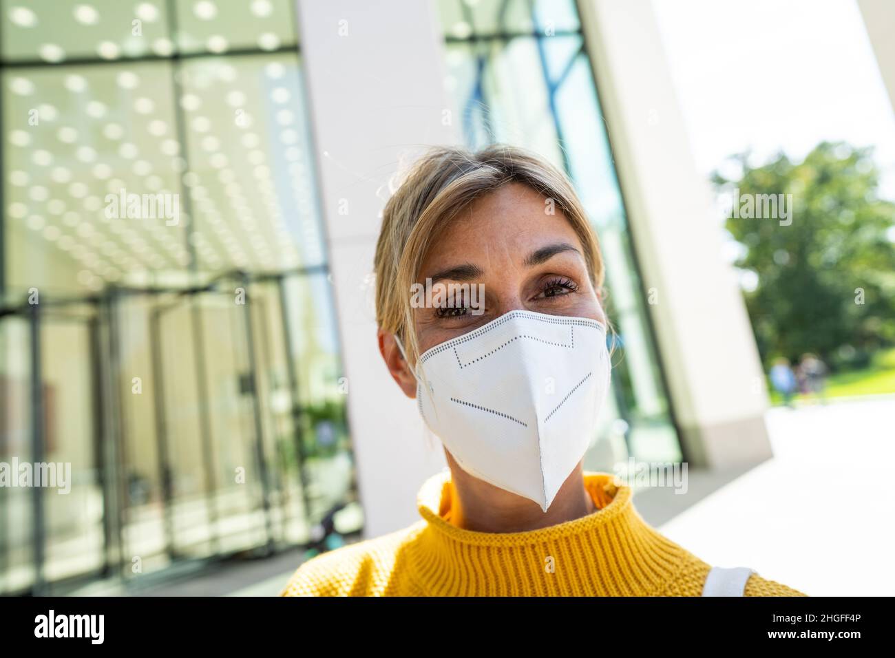 COVID-19 Pandemic Coronavirus Woman in city street wearing KN95 FFP2 ...