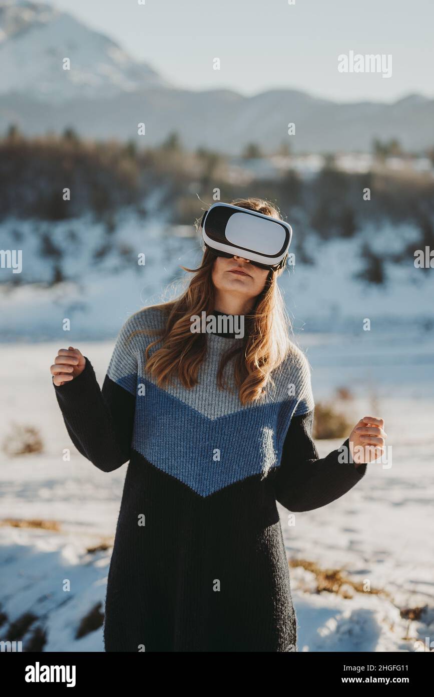 young woman with vr goggles enjoying outdoors Stock Photo