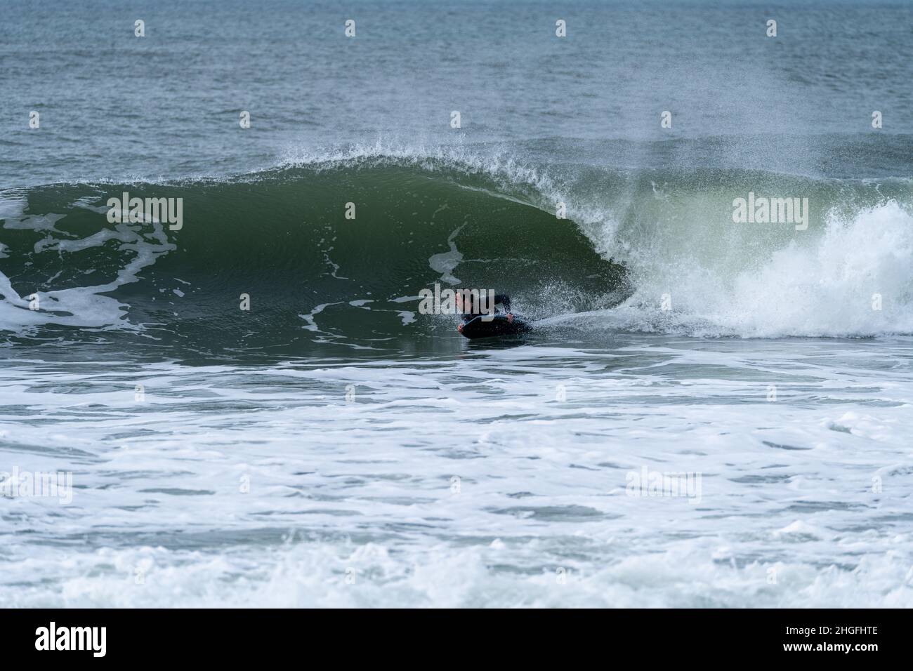 Ocean Wave Trick Roping Bodyboarder performing a tube trick surfing ocean wavesurfing ocean ...