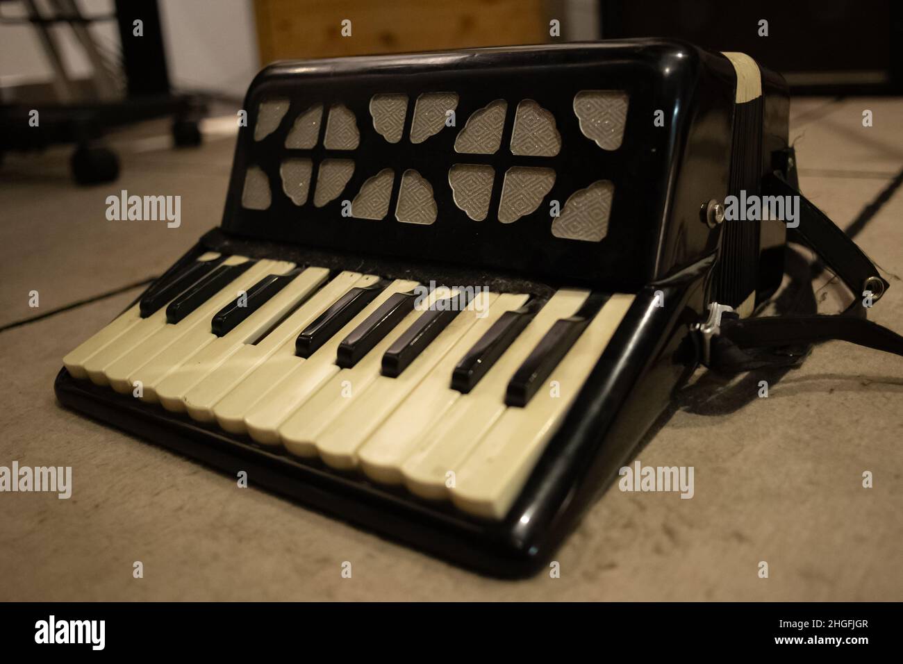 Small miniature piano on the floor of a music recording studio Stock Photo