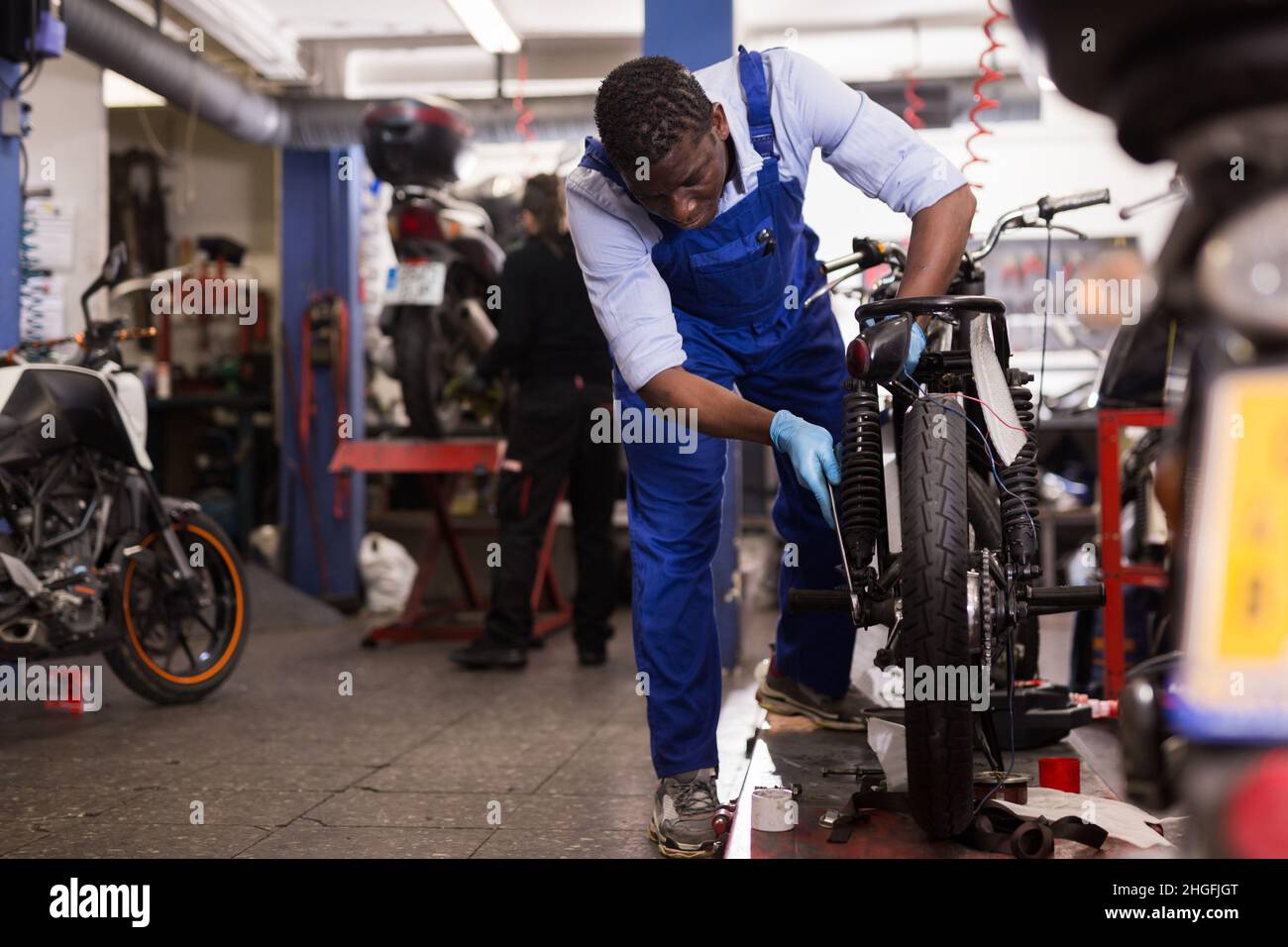 Motorcycle Service Work Service engineer repairs a motorcycle steering wheel in a motorcycle ...