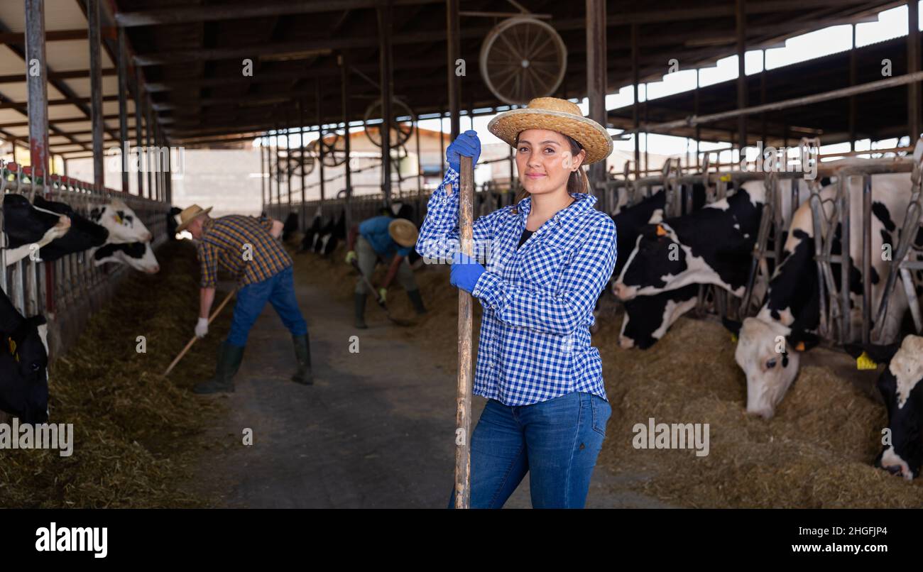 Woman farmer posing at cowshed on farm Stock Photo - Alamy